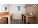 Unfinished basement featuring wood panel walls, two work tables, and overhead storage rack at 4639 Sloan Ave, Sarasota, FL 34233