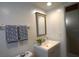 Modern bathroom featuring a vanity with sink, decorative towels, and soft lighting at 4639 Sloan Ave, Sarasota, FL 34233
