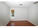 Bedroom with tile flooring, window with a blind, and neutral walls at 4639 Sloan Ave, Sarasota, FL 34233