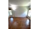 Bedroom with tile flooring and a standing lamp for soft, ambient lighting at 4639 Sloan Ave, Sarasota, FL 34233