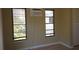 Bedroom with hardwood floors and windows with blinds to let in natural light at 4639 Sloan Ave, Sarasota, FL 34233