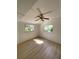 A well-lit bedroom is enhanced by hardwood floors and natural light from two windows at 4639 Sloan Ave, Sarasota, FL 34233