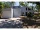 View of the front exterior showing architectural details and mature landscaping at 4639 Sloan Ave, Sarasota, FL 34233