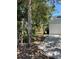 Exterior view of the garage with a side yard and tree line at 4639 Sloan Ave, Sarasota, FL 34233