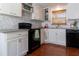 Updated kitchen features white cabinets, modern appliances, and tile backsplash at 4639 Sloan Ave, Sarasota, FL 34233