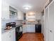 Well-lit kitchen with white cabinets, black appliances, and tile flooring throughout at 4639 Sloan Ave, Sarasota, FL 34233