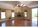 A spacious living room with a ceiling fan and a stone fireplace at 4639 Sloan Ave, Sarasota, FL 34233