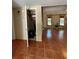 Spacious living room with tile floors, staircase, and closet, ideal for storage at 4639 Sloan Ave, Sarasota, FL 34233