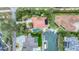 Aerial view of a waterfront property with a pool, dock, boat lift, and lush landscaping at 501 Sloop Ln, Longboat Key, FL 34228