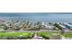 Golf course community aerial view, with waterfront homes, ocean access and clear blue waters at 501 Sloop Ln, Longboat Key, FL 34228