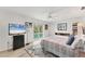 Bedroom featuring a light gray rug, a ceiling fan and view of the pool at 501 Sloop Ln, Longboat Key, FL 34228