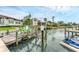 Waterfront exterior view featuring a boat lift and dock that is situated on the water at 501 Sloop Ln, Longboat Key, FL 34228