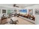 Bright living room with stylish decor, a ceiling fan, and a large flatscreen television at 501 Sloop Ln, Longboat Key, FL 34228