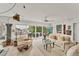 Bright living room boasts waterfront views, neutral color palette, and comfortable seating at 501 Sloop Ln, Longboat Key, FL 34228