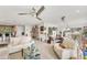 Open-concept living room featuring tile floors, bright light, and comfortable white sofas at 501 Sloop Ln, Longboat Key, FL 34228