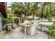 A custom outdoor kitchen area features a grill, counter space, and mature landscaping at 501 Sloop Ln, Longboat Key, FL 34228