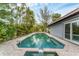 Backyard pool surrounded by tropical foliage and a paved deck, providing a private oasis at 501 Sloop Ln, Longboat Key, FL 34228