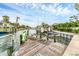 A clear, inviting pool surrounded by a brick patio and lush tropical landscaping in the backyard at 501 Sloop Ln, Longboat Key, FL 34228