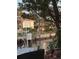 Waterfront exterior view featuring a boat lift, lush landscaping, and serene water reflecting the light at 501 Sloop Ln, Longboat Key, FL 34228