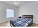 Cozy bedroom with a ceiling fan, light wood floors, and a large window with blinds at 5122 Northridge Rd # 112, Sarasota, FL 34238
