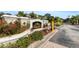 Community entrance featuring a decorative sign, lush landscaping, and a secure gate for residents at 5122 Northridge Rd # 112, Sarasota, FL 34238