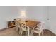 Cozy dining area with a wooden table, seating for six, and white walls at 5122 Northridge Rd # 112, Sarasota, FL 34238