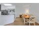 Dining area open to the kitchen, featuring a wooden table with seating for six at 5122 Northridge Rd # 112, Sarasota, FL 34238