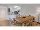 Light-filled dining room adjacent to the kitchen with a wooden table and six chairs at 5122 Northridge Rd # 112, Sarasota, FL 34238