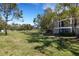 The property features a lush grassy area surrounded by mature trees at 5122 Northridge Rd # 112, Sarasota, FL 34238