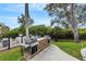Outdoor grilling area complete with a stone counter, grills, and views of the green landscape at 5122 Northridge Rd # 112, Sarasota, FL 34238