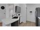 Bright kitchen featuring white counters, stainless steel appliances, and laminate floors at 5122 Northridge Rd # 112, Sarasota, FL 34238