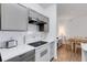 Well-lit kitchen featuring gray cabinets, white countertops, and stainless steel appliances at 5122 Northridge Rd # 112, Sarasota, FL 34238