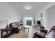 Comfortable living room with a leather sofa, bay window, and access to the patio at 5122 Northridge Rd # 112, Sarasota, FL 34238