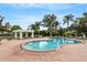 Enjoy this large community pool surrounded by lounge chairs, shady trees, and brick pavers at 5122 Northridge Rd # 112, Sarasota, FL 34238