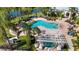 Aerial view of a resort-style pool and spa area, complete with lounge chairs at 5122 Northridge Rd # 112, Sarasota, FL 34238