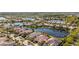 Beautiful aerial view of the community with lake view, manicured lawns, and tile roofs at 5509 Avellino Pl, Sarasota, FL 34238