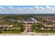 Aerial view showcasing a community with mature trees, lakes, and community center with pool at 5509 Avellino Pl, Sarasota, FL 34238