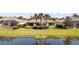 Backyard of home with well-manicured lawn and landscaping overlooking a tranquil lake at 5509 Avellino Pl, Sarasota, FL 34238