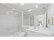Clean, white bathroom featuring a shower-tub combo, white vanity, and a large mirror at 5509 Avellino Pl, Sarasota, FL 34238