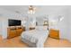 Bright bedroom with a ceiling fan, mirrored closet doors, and matching nightstands at 5509 Avellino Pl, Sarasota, FL 34238