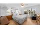 Comfortable bedroom featuring a ceiling fan, large window, and a cozy sitting area at 5509 Avellino Pl, Sarasota, FL 34238