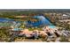 Aerial view of community center with pool, tennis courts and a sparkling lake in the background at 5509 Avellino Pl, Sarasota, FL 34238