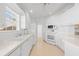 Bright kitchen featuring white cabinets, modern appliances, and tile flooring at 5509 Avellino Pl, Sarasota, FL 34238