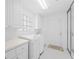 Well-organized laundry room with modern appliances, ample counter space, and plenty of storage at 5509 Avellino Pl, Sarasota, FL 34238