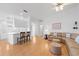 Open-concept living room with hardwood floors, a cozy couch, and a seamless flow to the kitchen at 5509 Avellino Pl, Sarasota, FL 34238