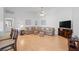 Bright living room featuring hardwood floors, a large sectional sofa, and neutral wall paint at 5509 Avellino Pl, Sarasota, FL 34238