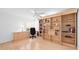 Well-lit office with built-in shelving, a desk area, and a window view at 5509 Avellino Pl, Sarasota, FL 34238