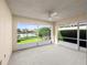 Relaxing enclosed patio with a ceiling fan and serene lake views at 5509 Avellino Pl, Sarasota, FL 34238