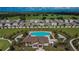 Aerial view of a community pool and recreation center at Creek Preserve with neighborhood homes nearby at 5547 Logan Cave Ave, Wimauma, FL 33598