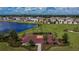 Aerial view of community basketball court by pond and homes in the Creek Preserve neighborhood at 5547 Logan Cave Ave, Wimauma, FL 33598